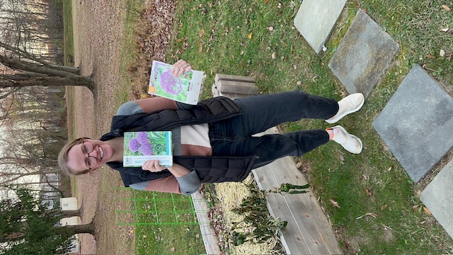 woman in garden holding bags of allium flower bulbs to plant